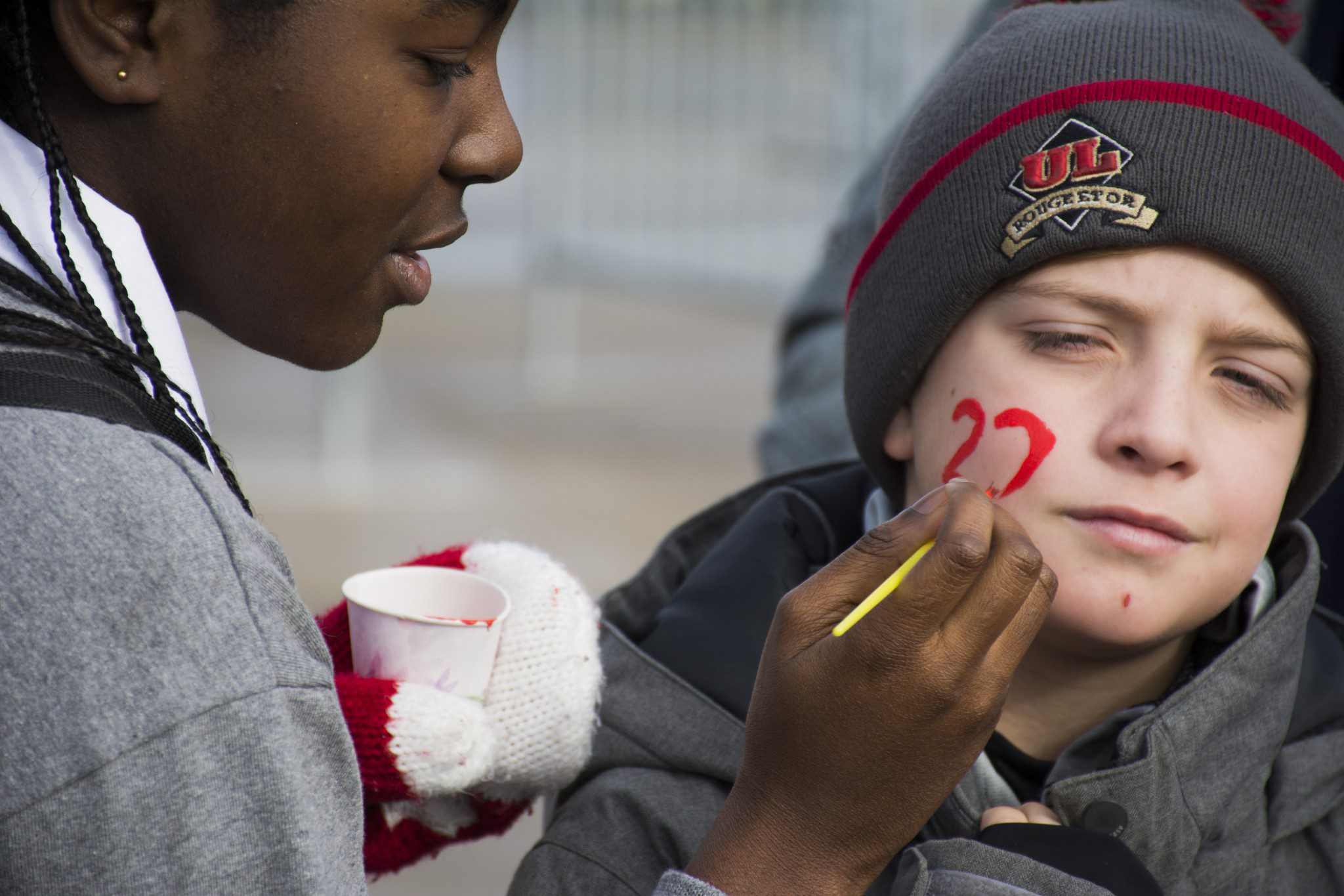 young fan getting his face painted