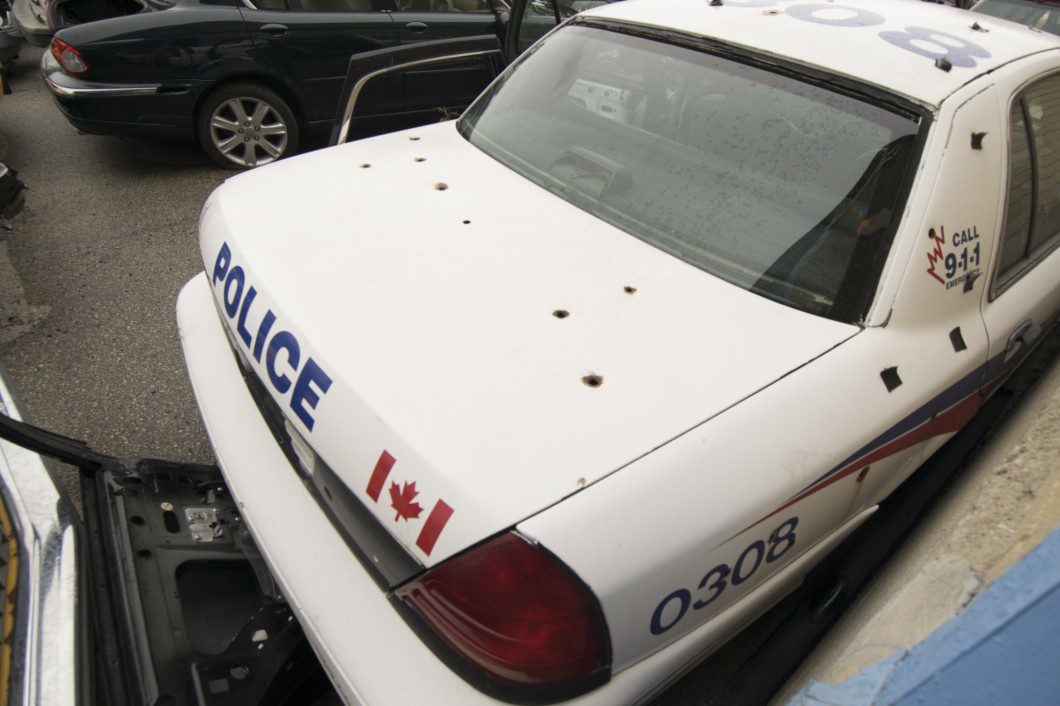 old police car with holes in trunk