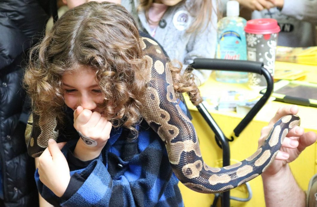 Child handling snake.