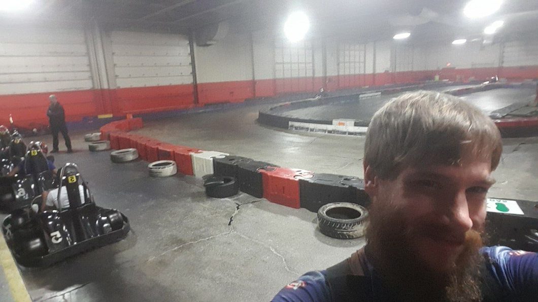 Matthew Hayley takes a picture of himself at the race track while standing in front of his go-kart.