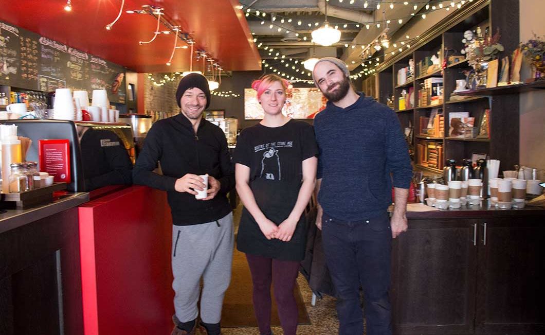 owner and baristas standing