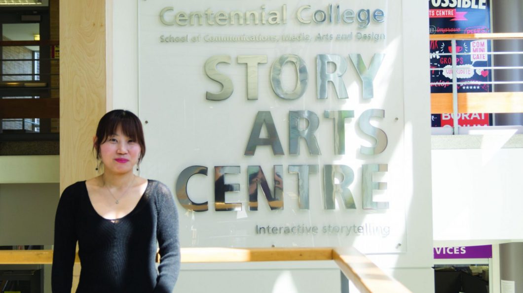 G-Hey poses in front of the Story Arts Centre sign. She made a short film for a class project that got chosen to be made into a feature-length film.
