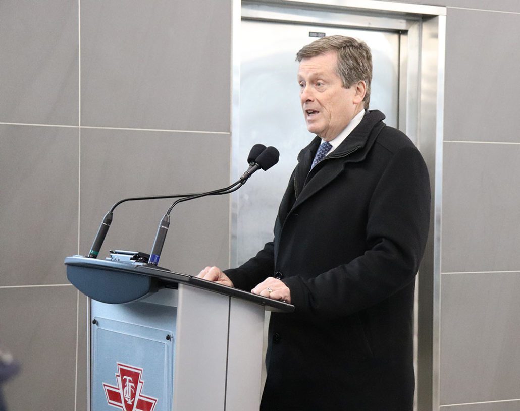 Mayor Tory speaks from a podium at Pape Station