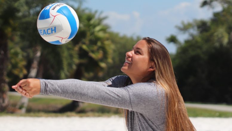Fernanda Reis prepares to hit a volleyball during practice