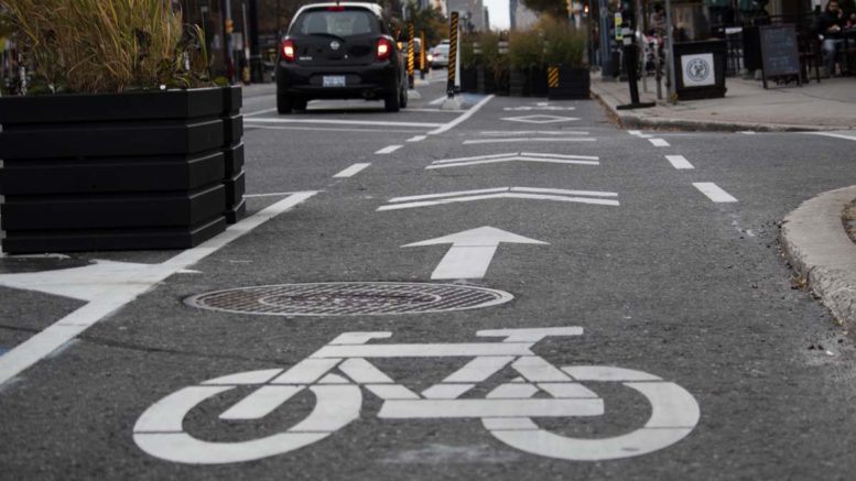 Close up bike lane icon on Danforth Avenue in Toronto's East York.