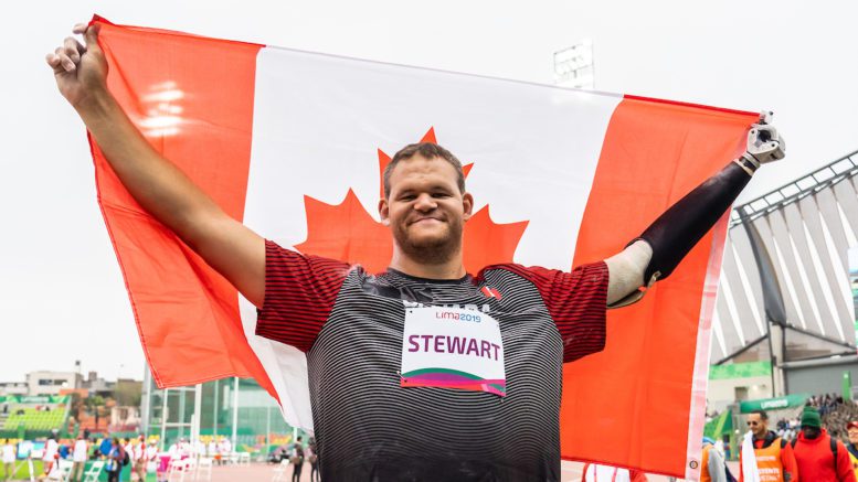 Canadian athlete, Greg Stewart, celebrates with the Canadian flag at Lima 2019 Parapan Games
