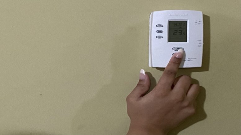 Hand adjusting thermostat.