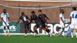 Players from Forge FC celebrate Woobens Pacius' goal against York United during a CPL match.