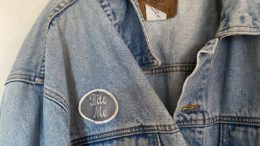 A thrifted jean jacket with a patch reading "bite me"