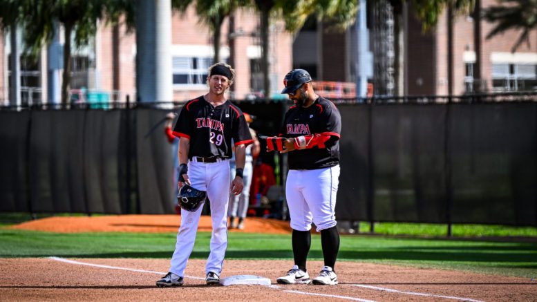 Luke Glancy talking to the University of Tampa Spartans baseball first base coach