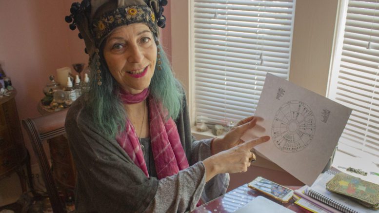 Astrologer and tarot reader, Tara Greene, smiling while conversing about the relationship between astrology and politics.