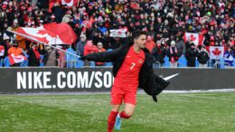 Canadian midfielder Stephen Eustáquio hoisting the flag