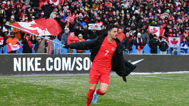 Canadian midfielder Stephen Eustáquio hoisting the flag