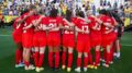 Canadian Women's National Soccer Team huddles on the field