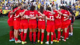 Canadian Women's National Soccer Team huddles on the field