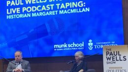 Paul Wells and Margaret MacMillan sit on-stage for his episode of The Paul Wells Show podcast at the Munk School of Global Affairs & Public Policy.