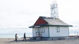 Two people passing a lifeguard station on Woodbine Beach
