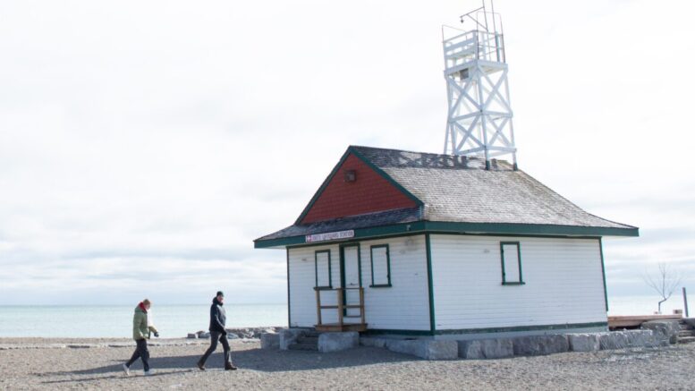 Two people passing a lifeguard station on Woodbine Beach