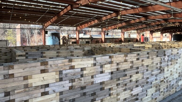 A maze of gathered wooden blocks inside industrial pavilion at Evergreen Brickworks