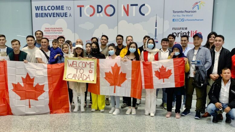Canadians and Refugees members holding Canadian flags at Toronto's Pearson International Airport. (Courtesy Canadians and Refugees)