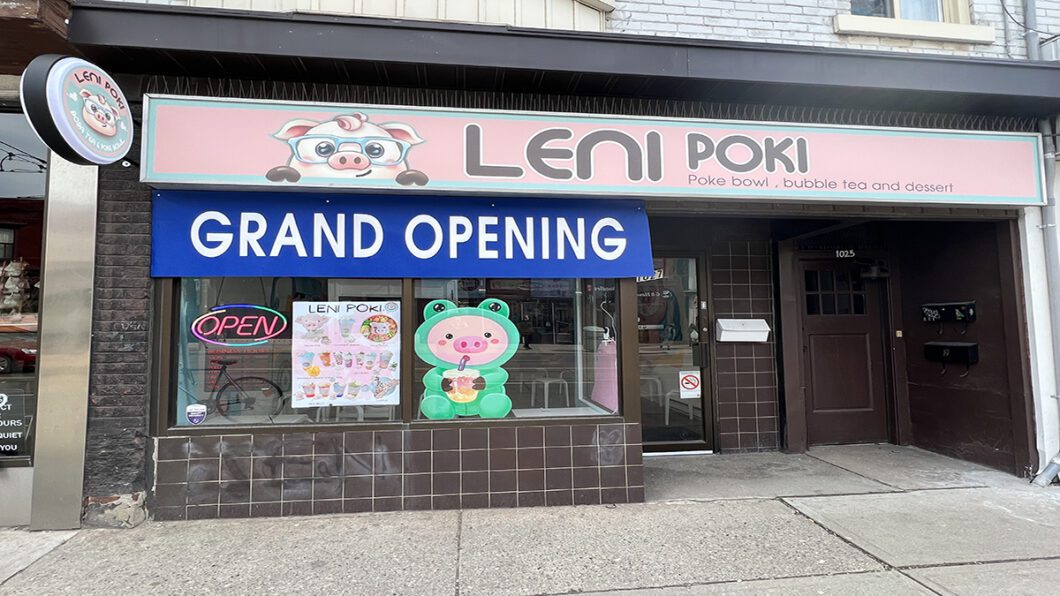 Grand opening sign on Leni Poki storefront.
