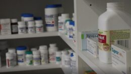 Different types of medicines are placed on shelves.