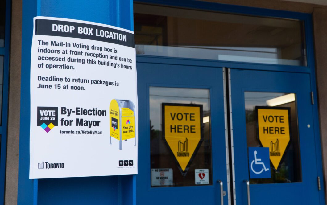 Signs on the doors of an advance polling station in East York