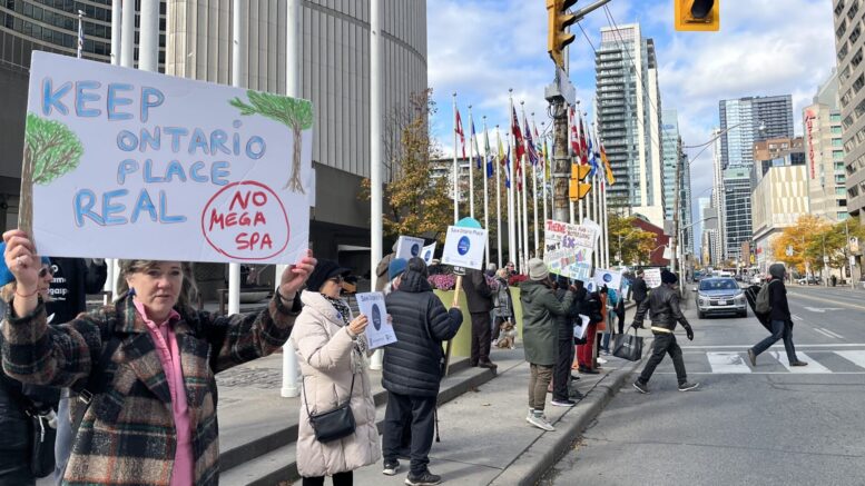 OntarioPlace4All supporters holding up protest signs along Bay street in Toronto