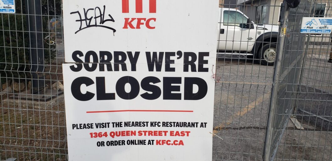 Closed KFC sign notice at Pape Avenue and Sammon Avenue directing customers to visit the nearest KFC location at 1364 Queen Street East.