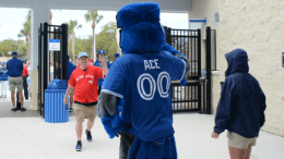 fans walking past Blue Jays mascot Ace
