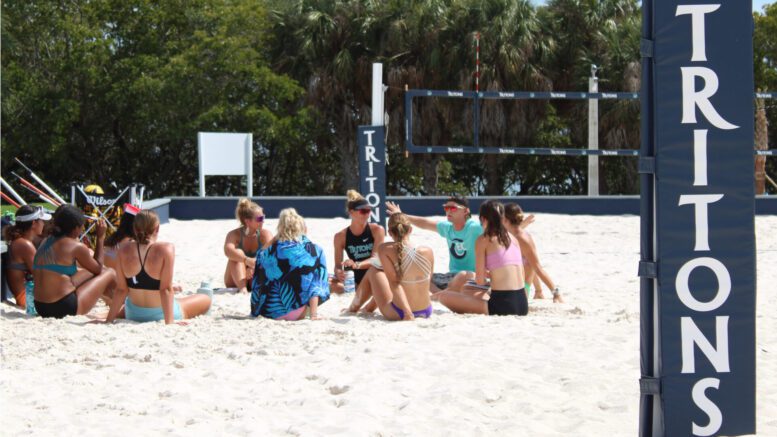Eckerd College Tritons Beach Volleyball team hold a Culture meeting on the court before practice.
