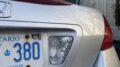 Silver Honda with an old licence plate renewal sticker dated just after the move to online renewals. (James Bullanoff/Toronto Observer) 