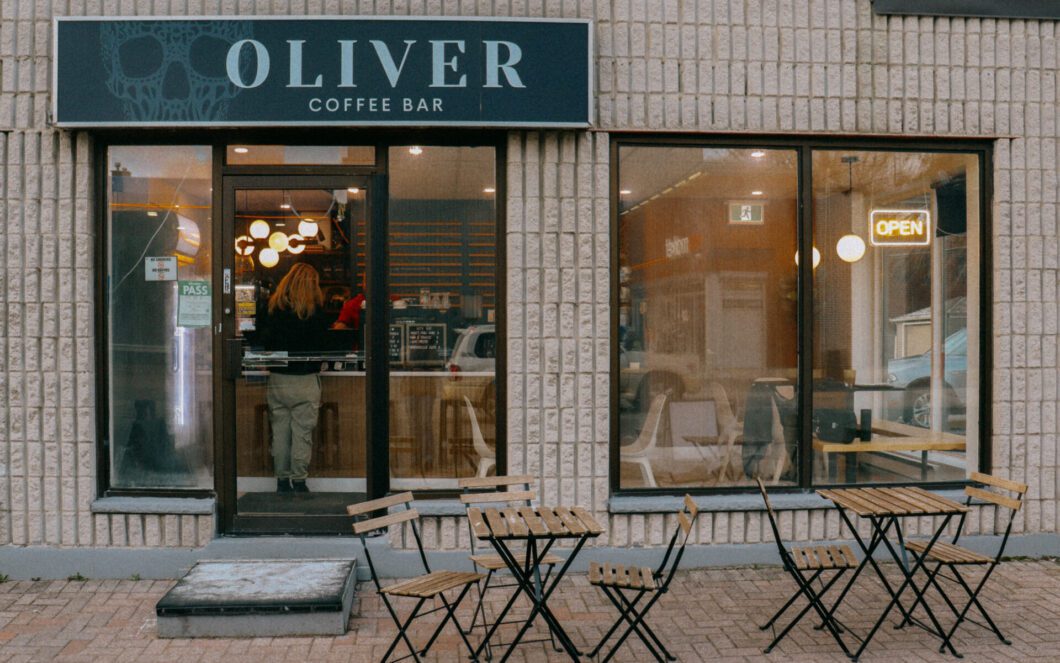 An outside view of Oliver Cafe with chairs and tables in front