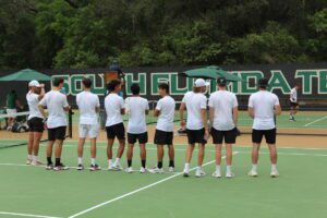 USF Men's Tennis team watches the final match of the day.