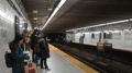 Passengers are waiting for the TTC train on the platform.