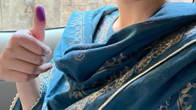 A women from Lahore posing for a photo after voting in Pakistan's general elections 2024