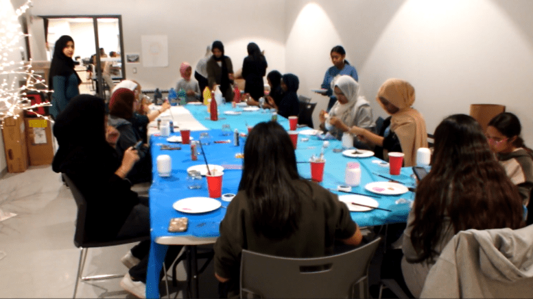 Image shows youth participating in arts and craft event at The Neighbourhood Organization.